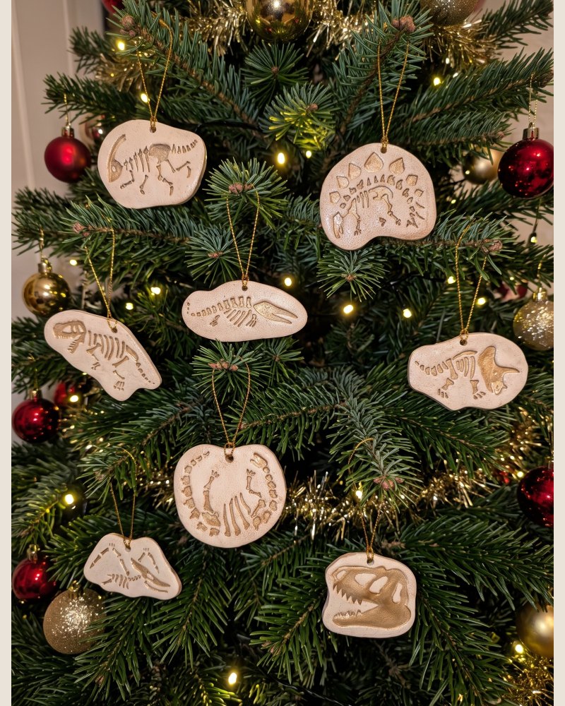Set of 8 Dinosaur fossil Christmas tree decorations with gold details on a tree