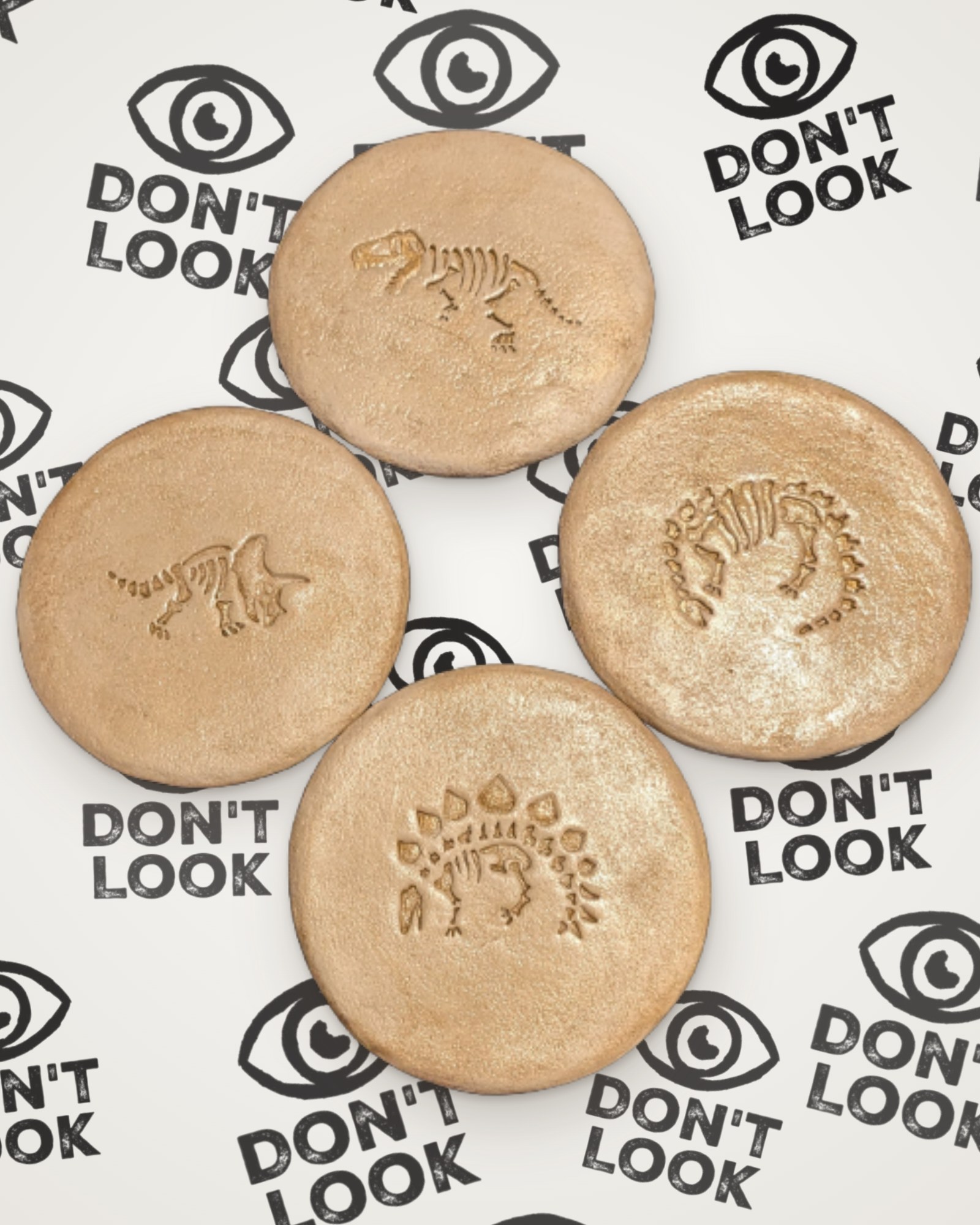 Set of 4 dinosaur fossil coasters in gold