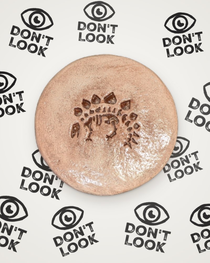Stegosaurus fossil coaster in brown