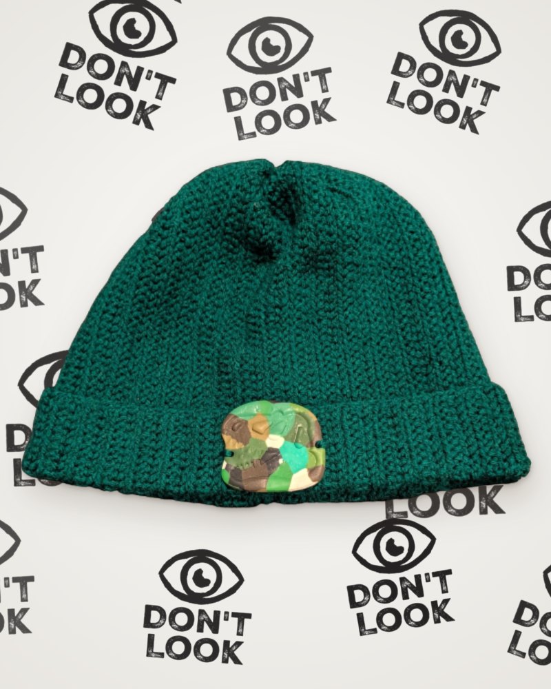 Green crochet beanie with camouflage T-Rex skull detail