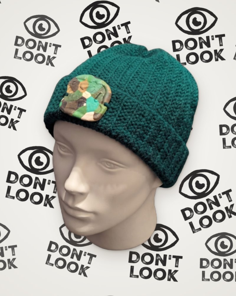 Green crochet beanie with camouflage T-Rex skull detail