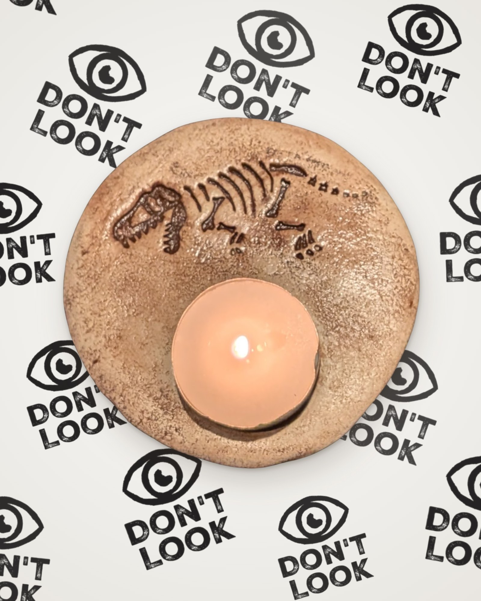 T-Rex fossil tealight holder in brown